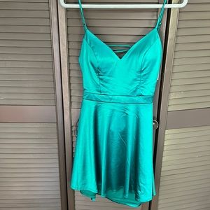 Emerald green cocktail junior dress with straps in the back. Brand new.